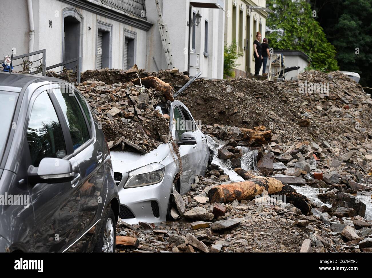 Hagen, Germany. 15th July, 2021. Residents look at the damage caused by the flooding of the