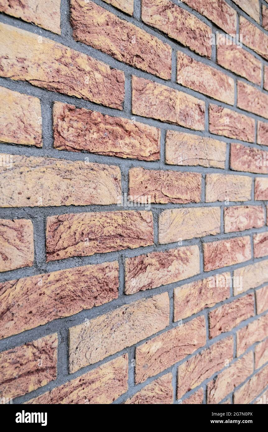 Red brick wall, stretcher bond, simplest repeating pattern of brickwork, rows of bricks, side view with diminishing perspective Stock Photo