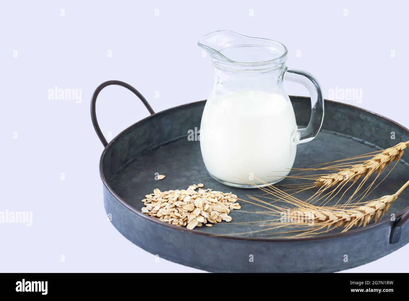 Vegan oat milk, bio non dairy alternative milk in glass jug Stock Photo