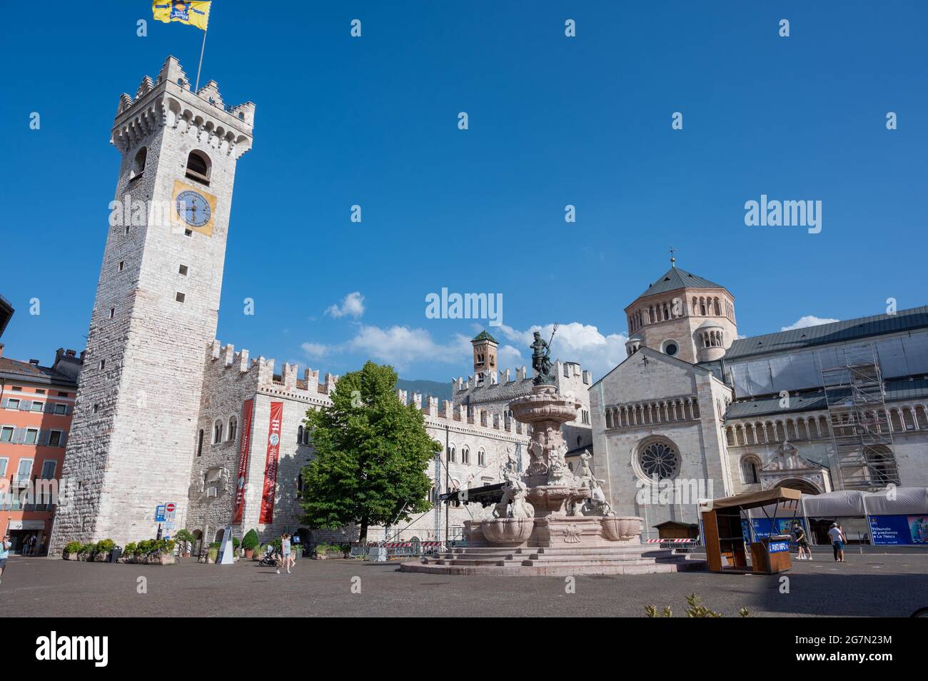 Trento, Italy, June 2021. Nice view of the main square: in evidence the bell tower, the fountain of Neptune and the cathedral. Nice sunny day. Stock Photo