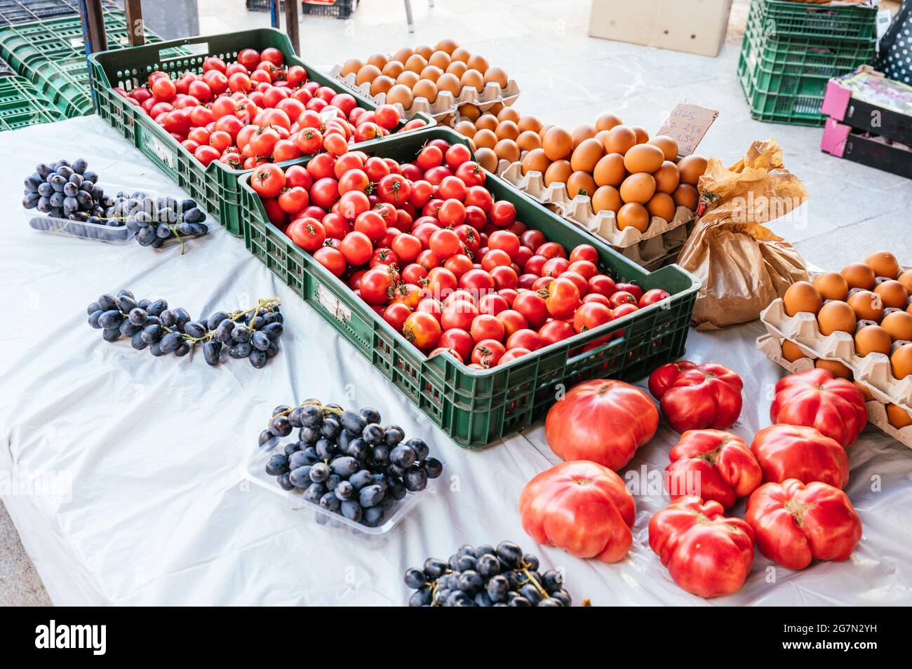 Local flea market stall with grapes, tomatoes and eggs for sale Stock ...