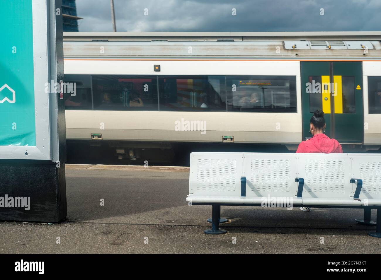 Girl on train platform, Clapham Junction,London, England Stock Photo