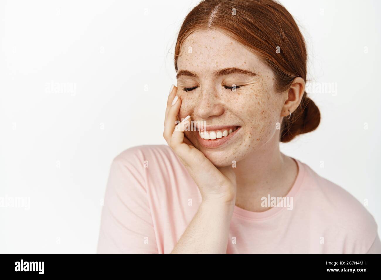 Women beauty. Pretty candid redhead girl laughing, smiling with white