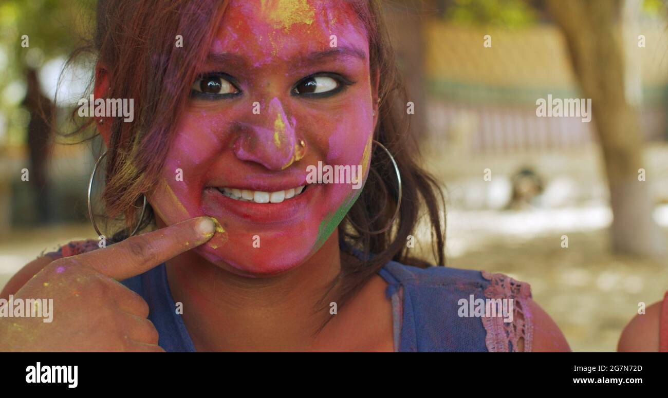 Closeup shot of an Indian woman with a coloured face on the festival of ...