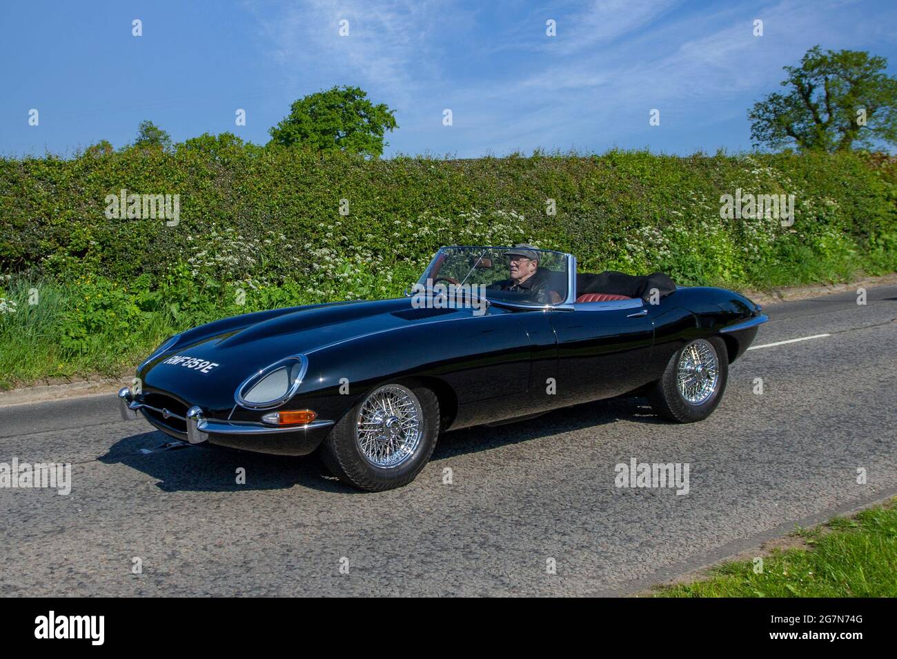 1967 60s sixties black Jaguar E Type en-route to Capesthorne Hall classic May car show, Cheshire, UK Stock Photo
