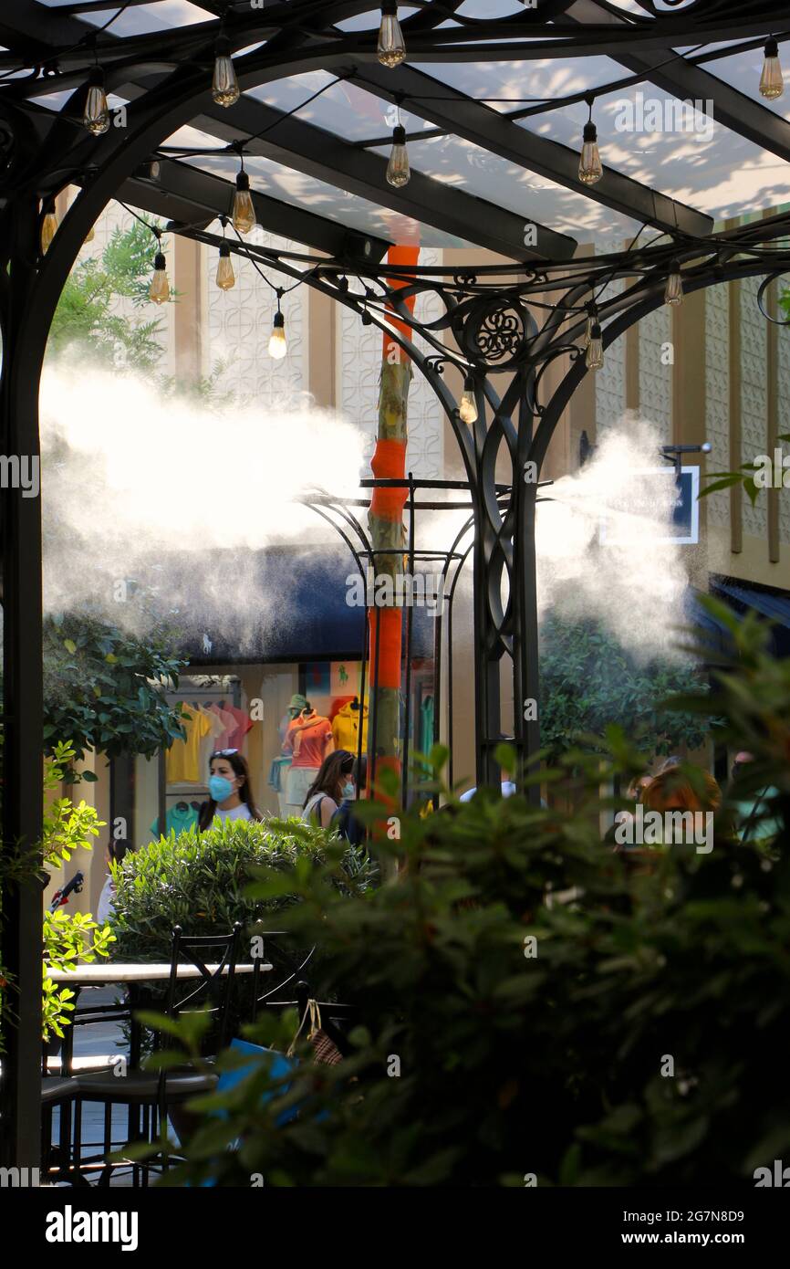 Las Rozas Shopping Mall Madrid Spain with water vapour sprayed to help with  a hot day Stock Photo - Alamy