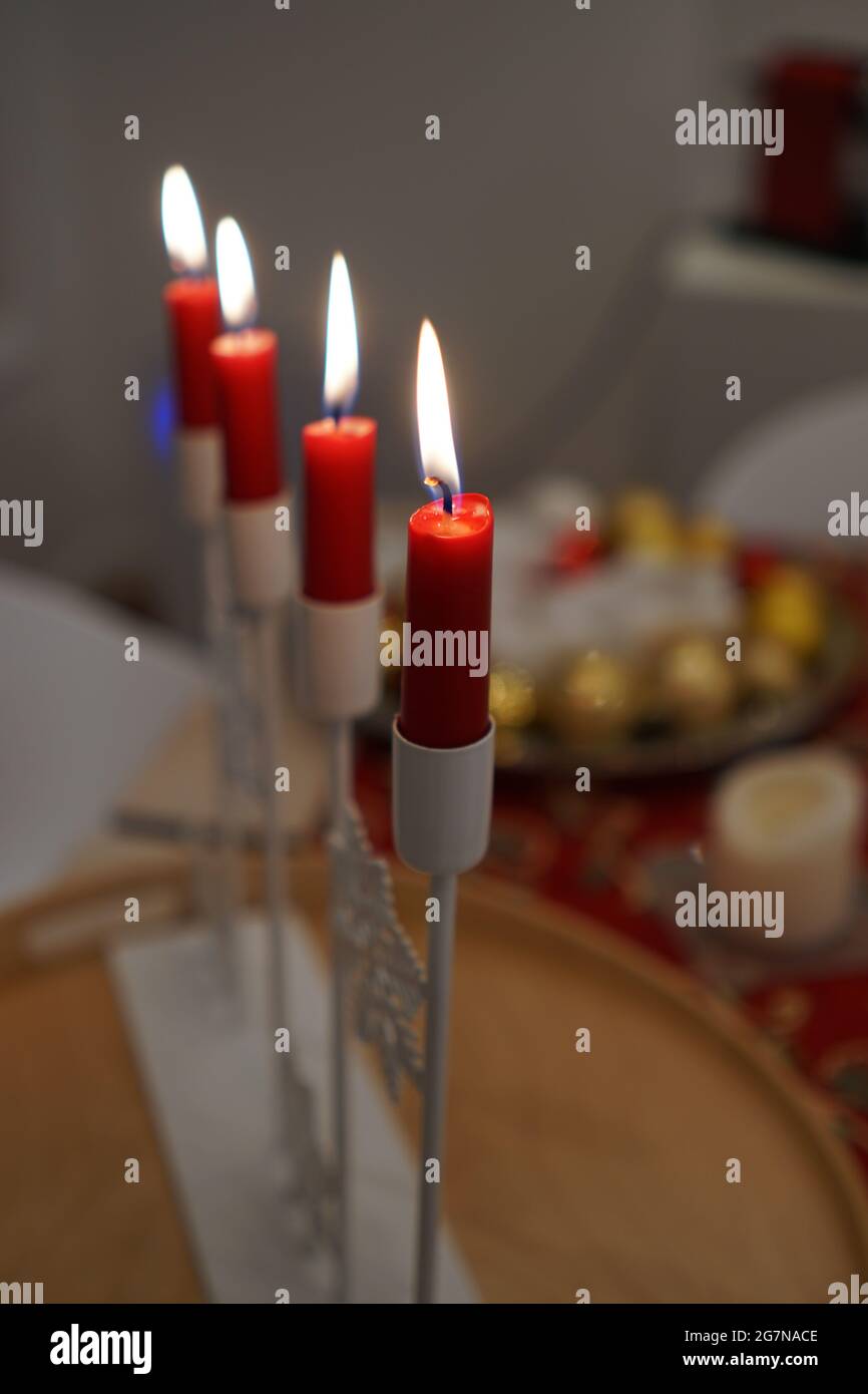 Selective of lit red candles on a white candelabra Stock Photo Alamy