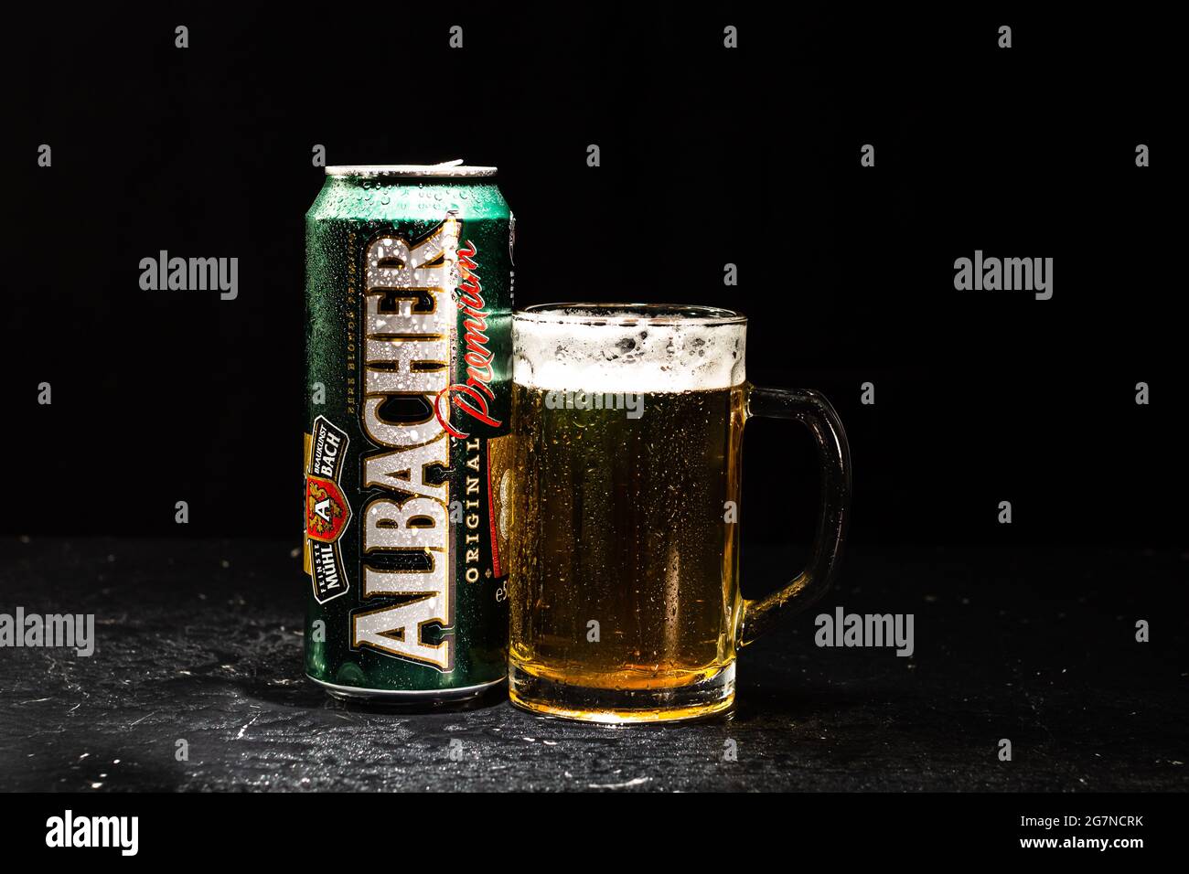 Can of Albacher beer and beer glass on dark background. Illustrative ...