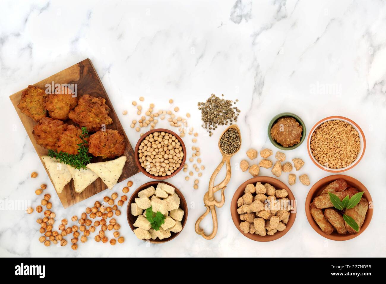 Vegan health food for a healthy diet with tofu bean curd, bhajis,  samosas, tvp, miso, soybeans, chickpeas. Plant based health foods. Stock Photo