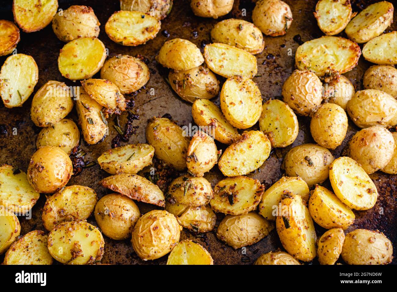Roasted Herb Mustard Potatoes on a Sheet Pan Roasted baby Yukon gold potatoes on a metal baking