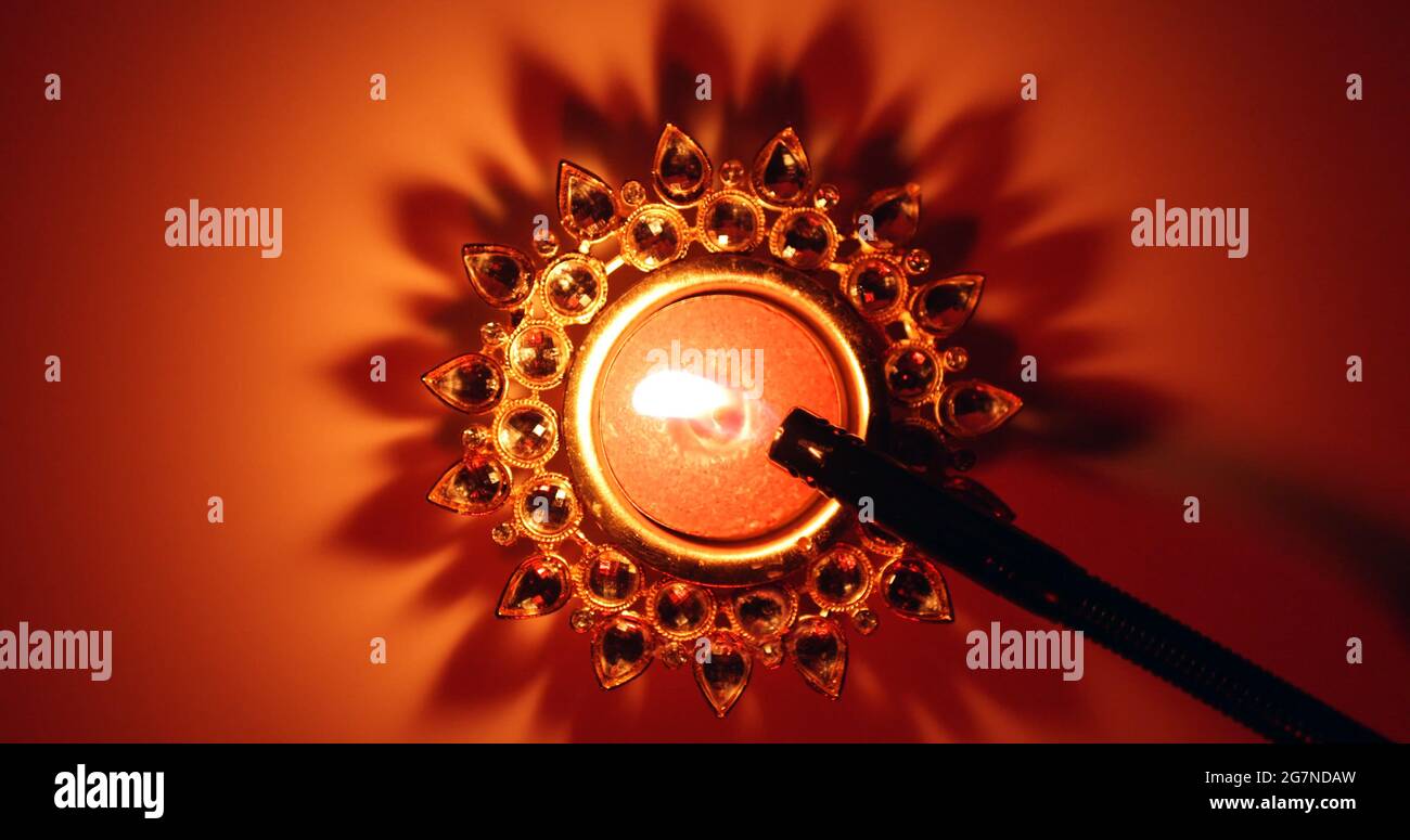 Top view of a decorative Diwali candle being lit Stock Photo Alamy