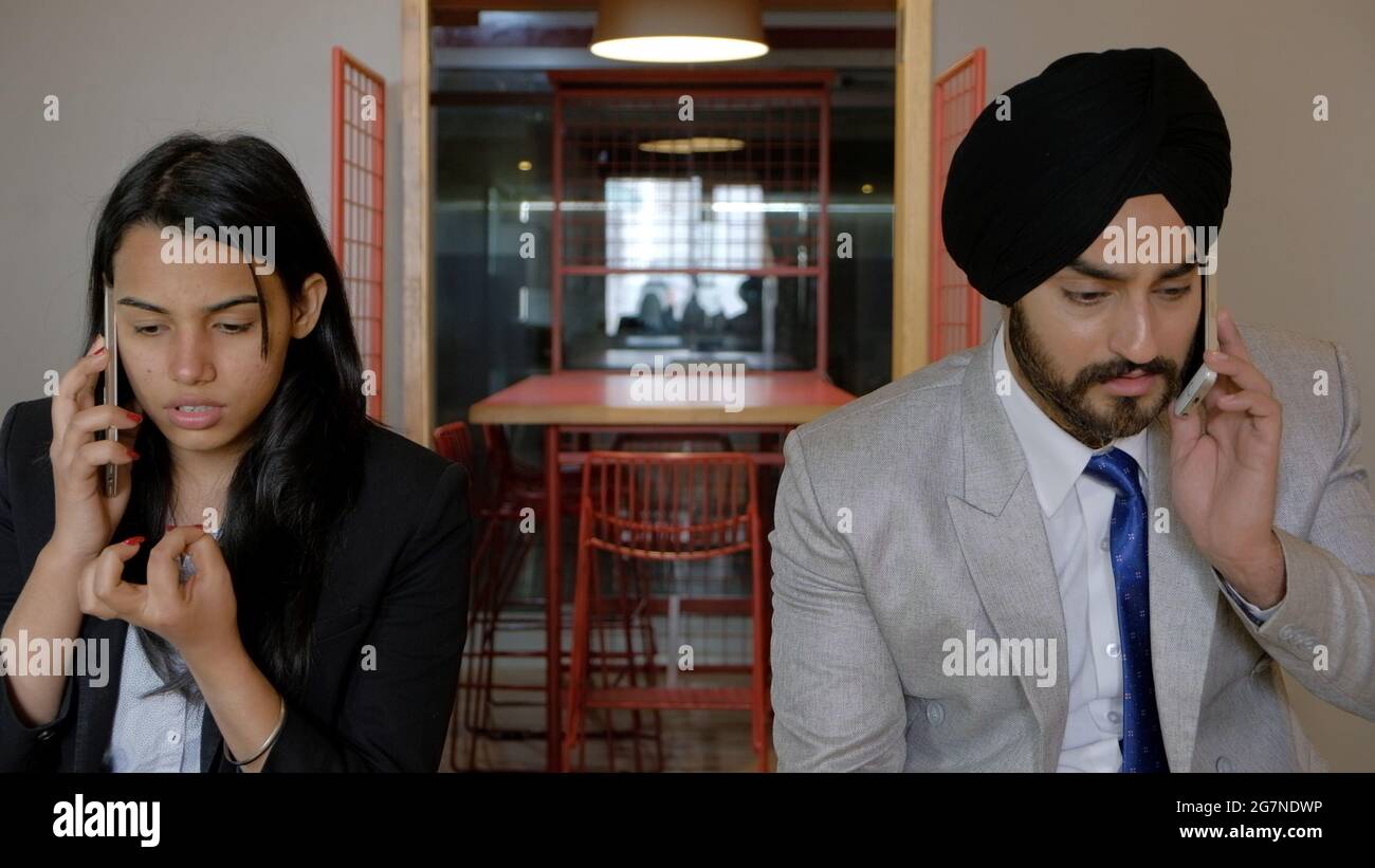 Shallow focus of an Indian man and woman talking on the phone Stock ...