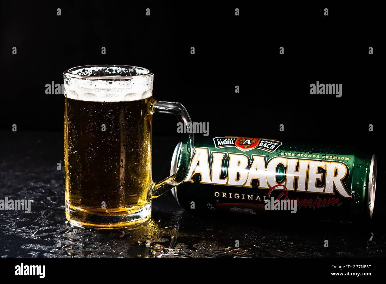 Can of Albacher beer and beer glass on dark background. Illustrative ...
