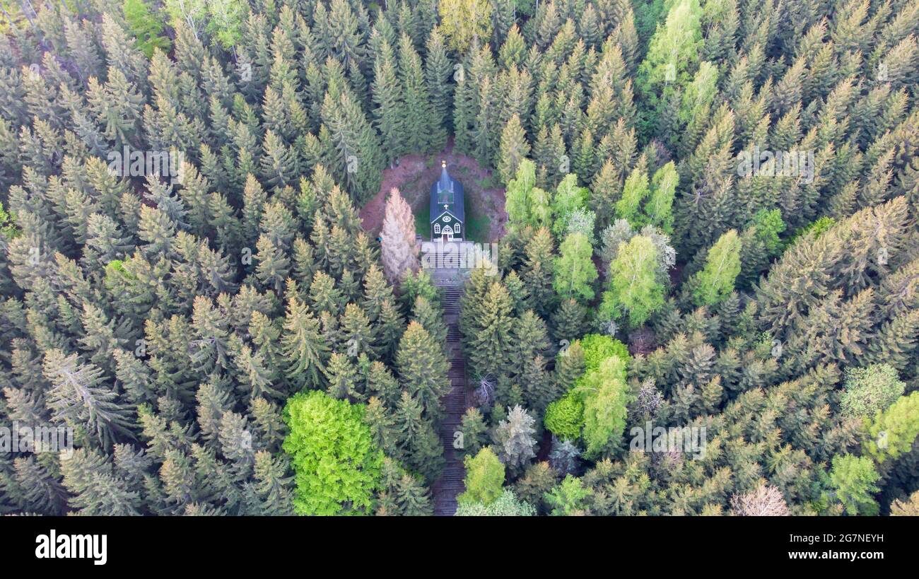 Aerial view of wooden rural chapel called Tichackova kaple in Broumovsko region,Czech republic.Catholic church in spring countryside.Religious Stock Photo