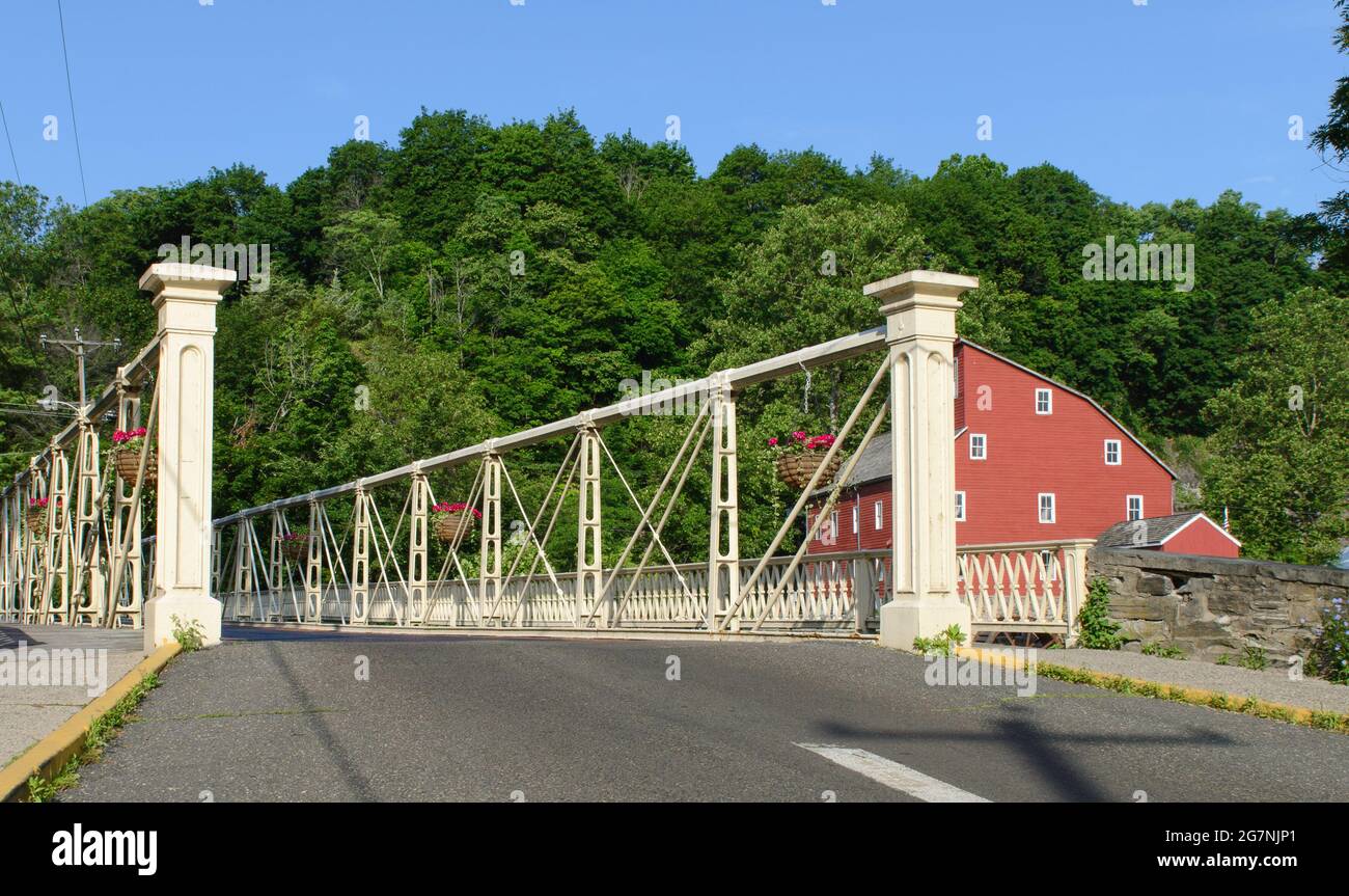 Crossing bridge with the Old Red Mill in the background in Clinton, New Jersey Stock Photo