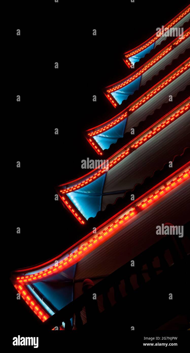 Red and blue neon lights on a pagoda with a black background in Pennsylvania, USA. Stock Photo