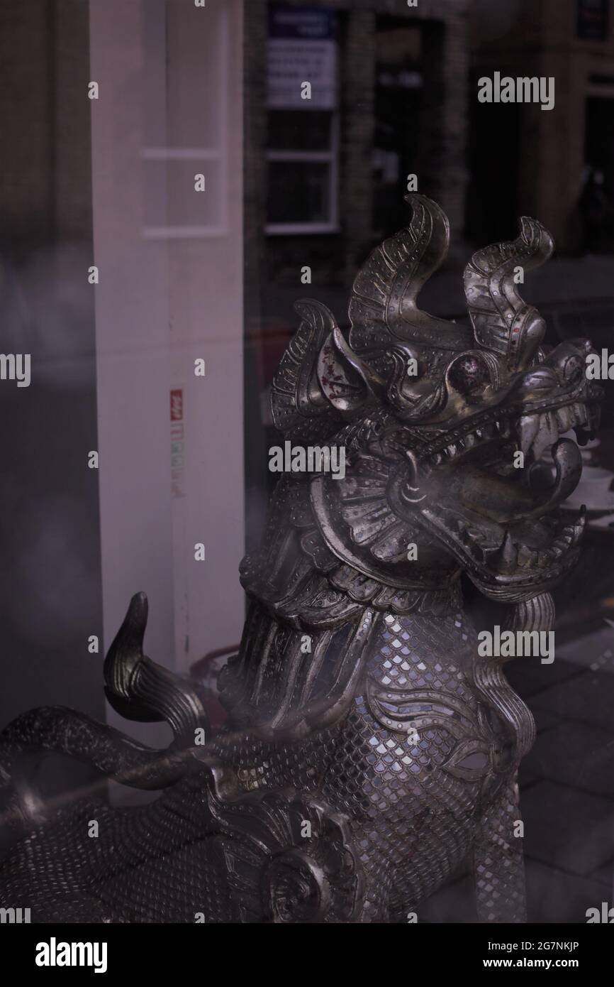 Oriental Dragon Statue in Front of the Entrance to a Chinese Restaurant