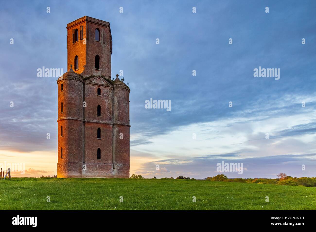 Sunrise at Horton Tower in Dorset, a five storey 43 metres high gothic red brick observatory / folly designed by Humphrey Sturt in the 18th century. Stock Photo
