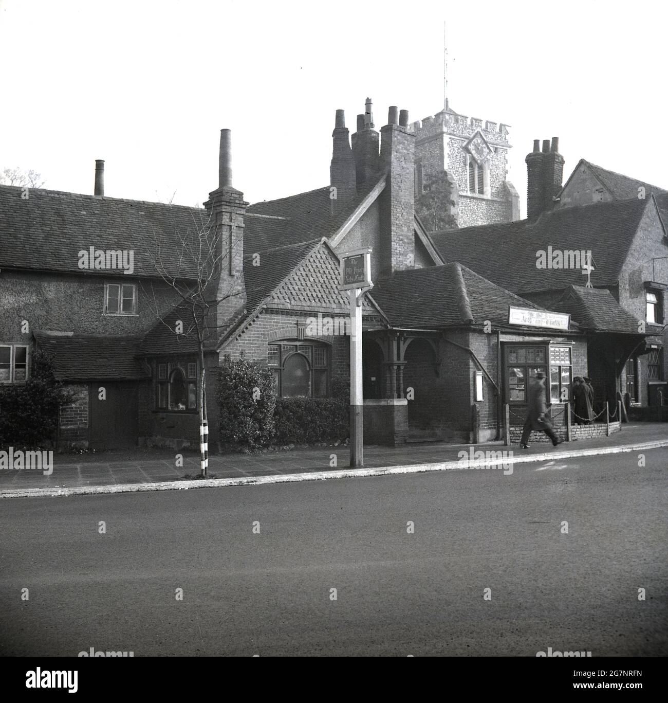 1950s, historical, The Old Priory, with sign outside saying Arts & Crafts, Ruislip, Hillingdon, London, England, UK. The parish is mentioned in the Domesday Book. A tower of St Martin's Church can be seen, a building which dates back to the 13th century. It was named after Saint Martin of Tours whilst under the ownershp of the monks of Bec. Abbey. in this era, Ruislip was in the county of Middlesex. Stock Photo