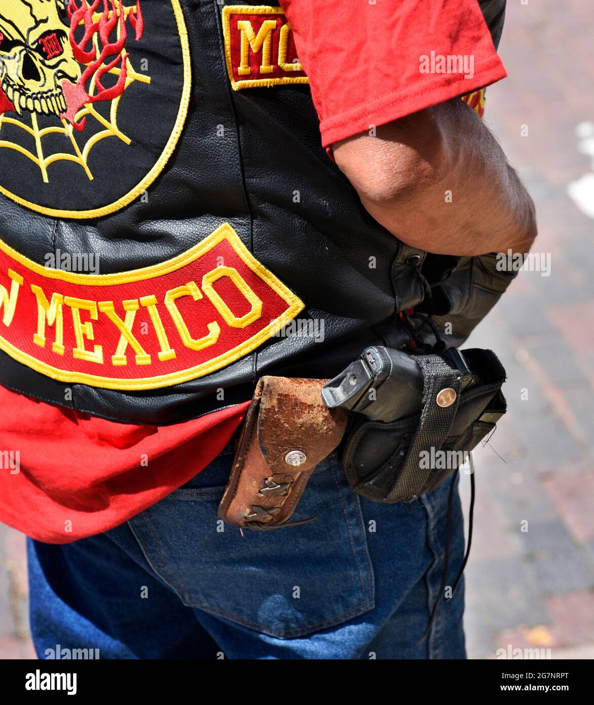 A man wearing a motorcycle club leather wears a holstered loaded handgun in  public at a Fourth of July classic car show in Santa Fe, New Mexico Stock  Photo - Alamy