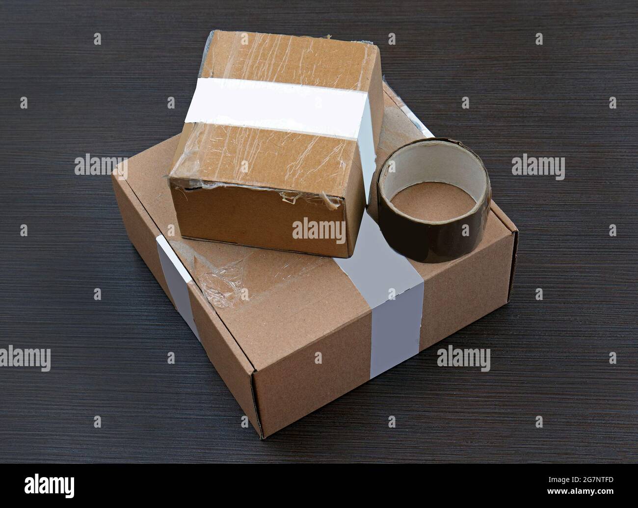 Packed cardboard boxes with duct tape on wooden surface ready for shipment  Stock Photo - Alamy