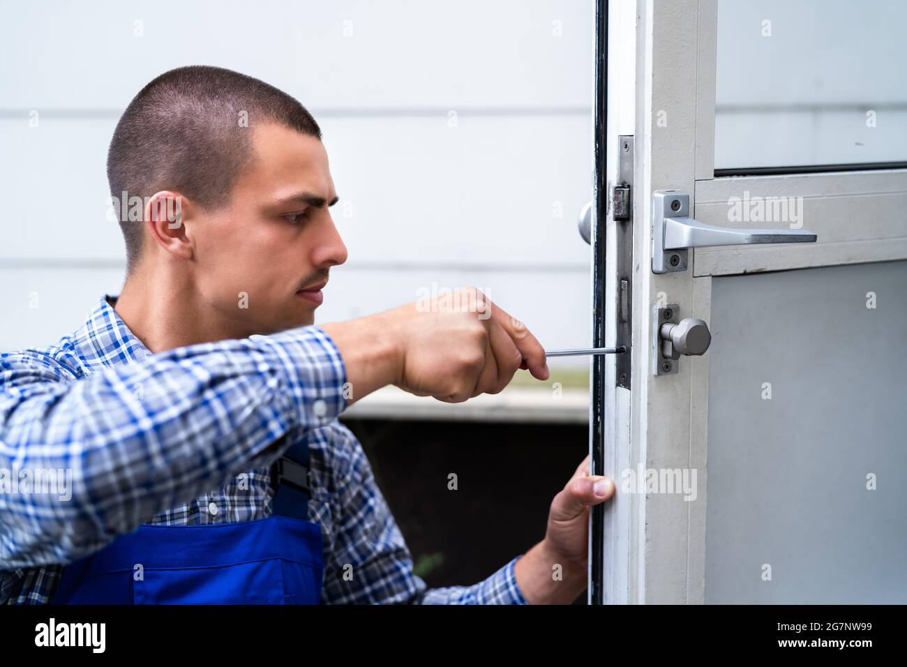 Locksmith Lock Door Repair. Worker Changing And Cylinder Stock Photo