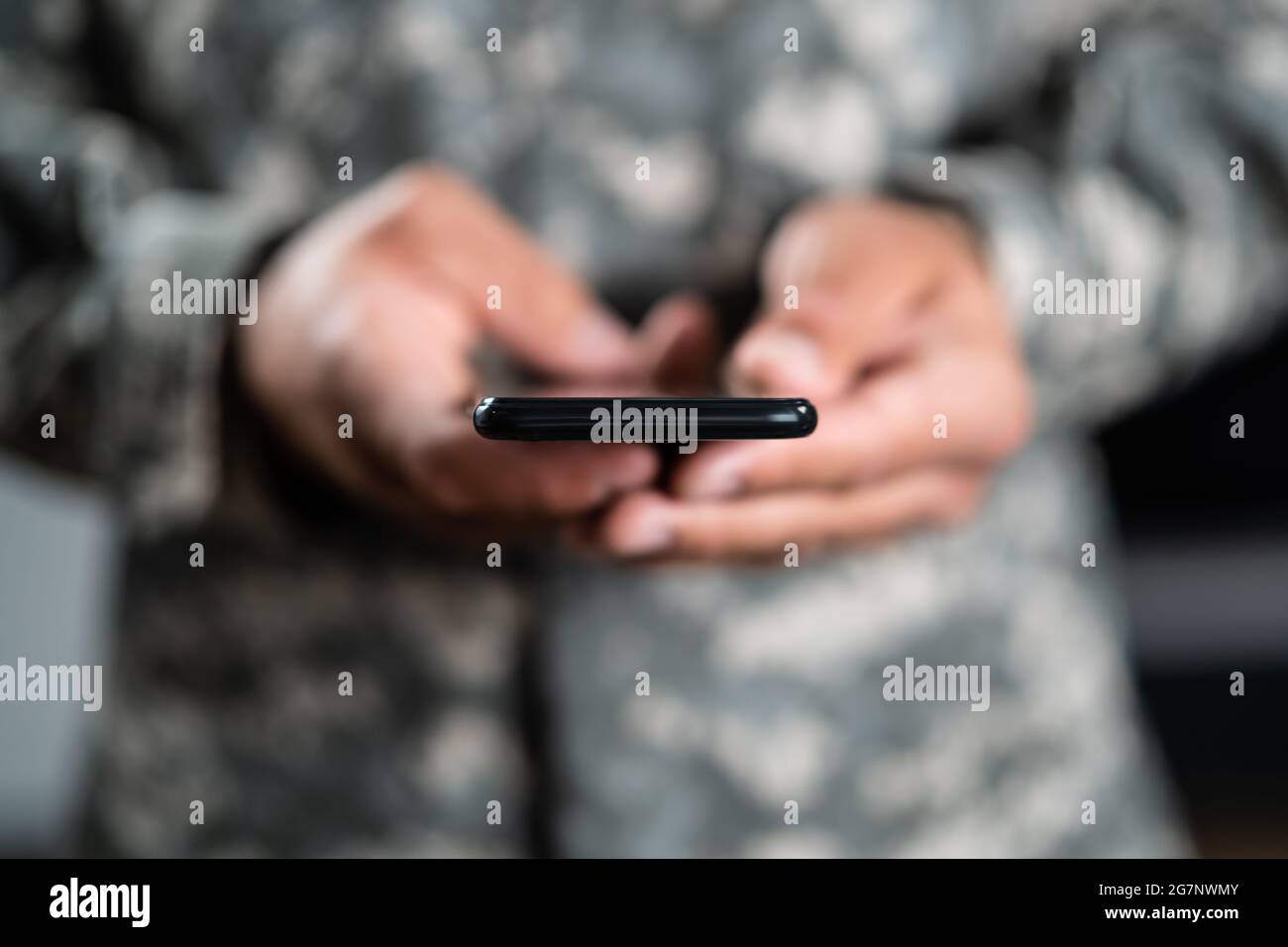 US Military Soldier Smart Phone Espionage. Cyber War Stock Photo