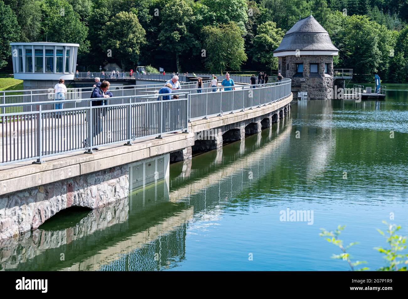 Attendorn, Germany. 15th July, 2021. Visitors stand on the Lister reservoir and look at the water. Due to the storms of the past few days, the dams in the Sauerland are very full. Credit: Markus Klümper/dpa/Alamy Live News Stock Photo