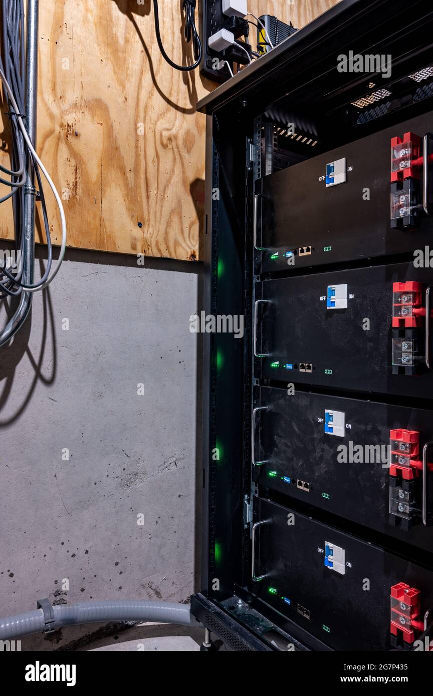 bank of electric batteries in a residential house used for backup power or in conjunction with solar energy storage Stock Photo