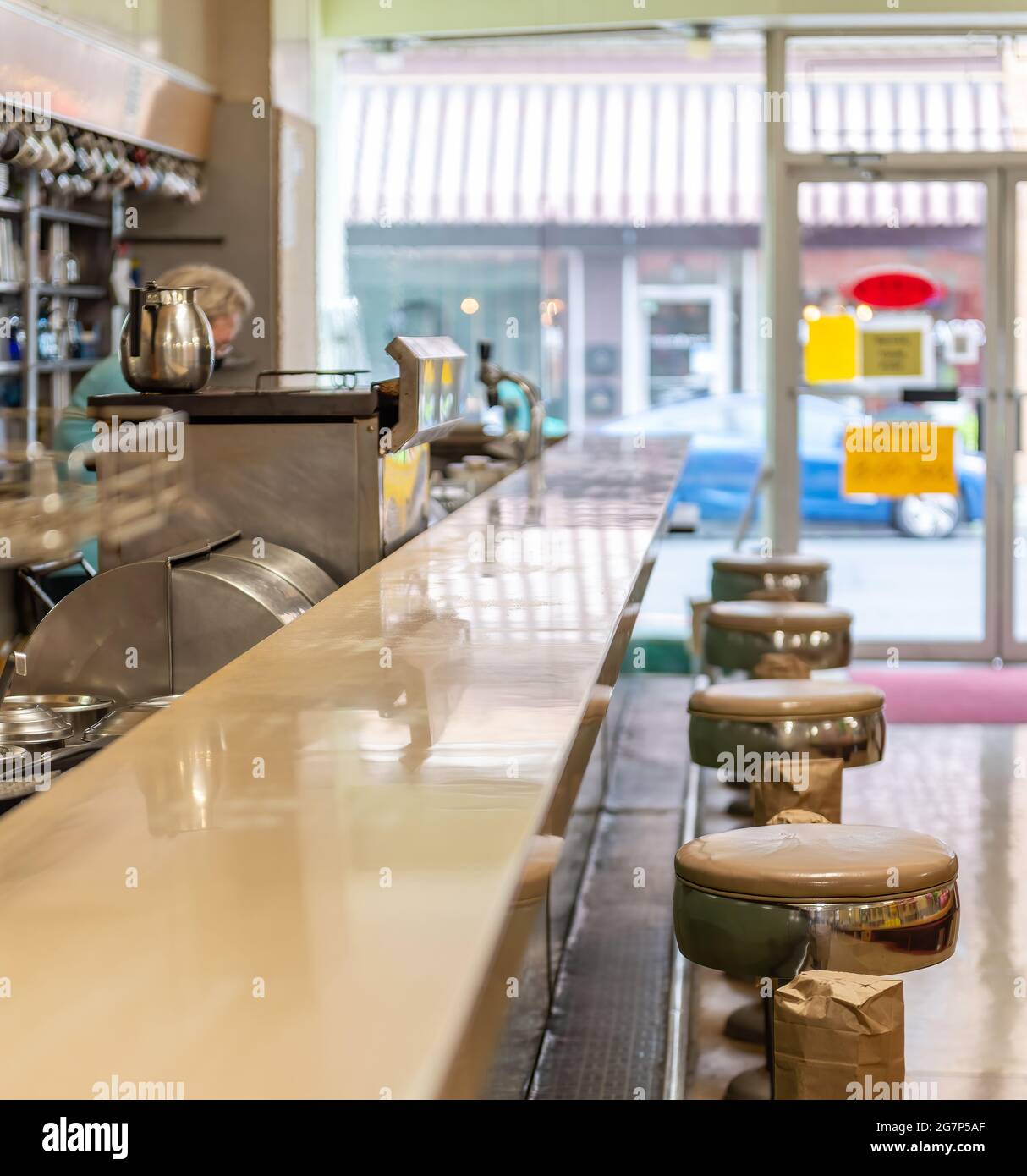 Original old diner with vinyl barstools at a counter and authentic, old stainless steel equipment in a town in New Jersey. Stock Photo