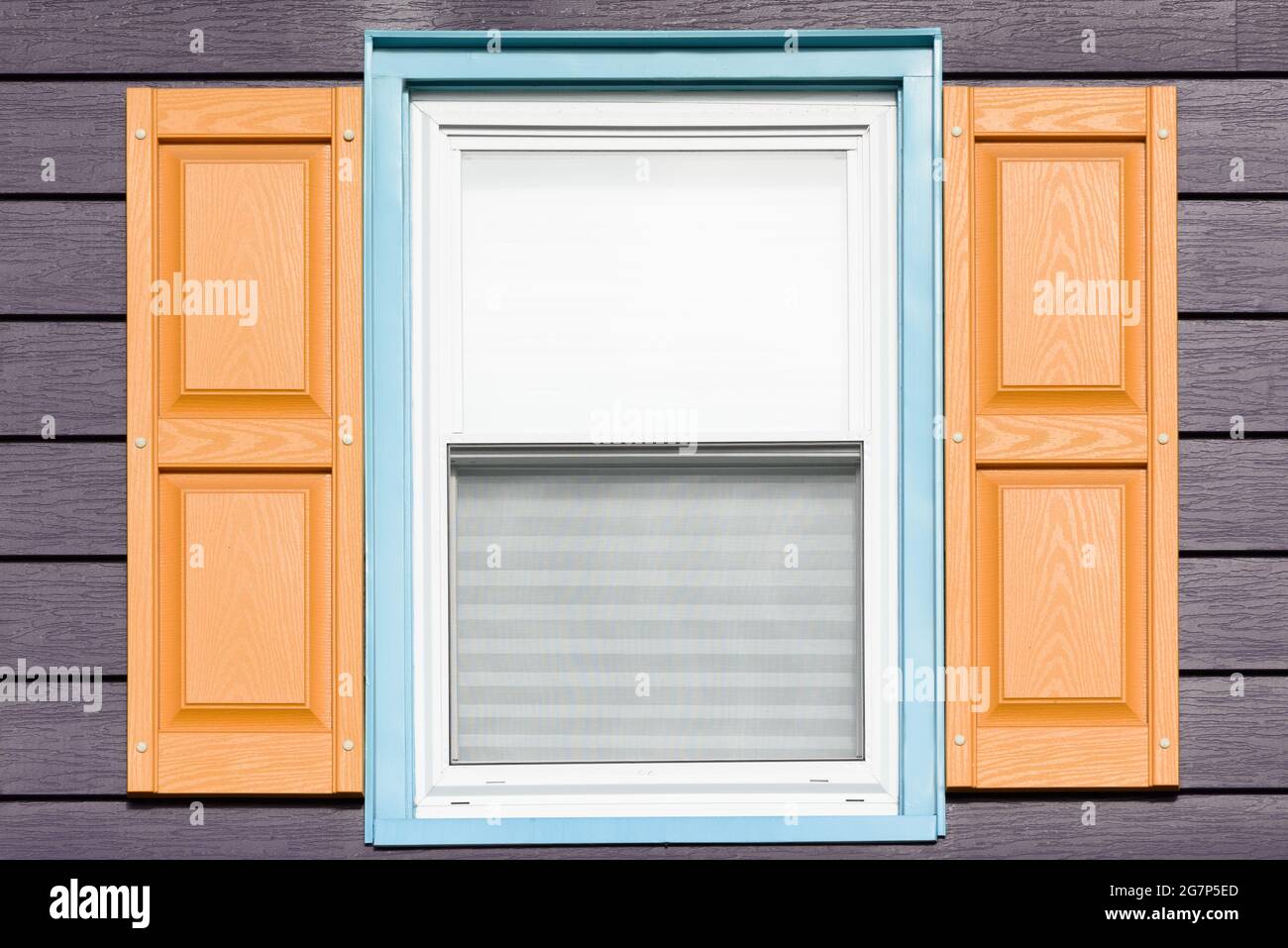 Creative, contemporary window colors shown on a close up of one window on a home. Stock Photo