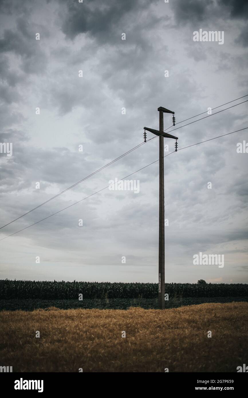Utility Field Ground Vertical shot of a big open field under the gray cloudy sky with a ...