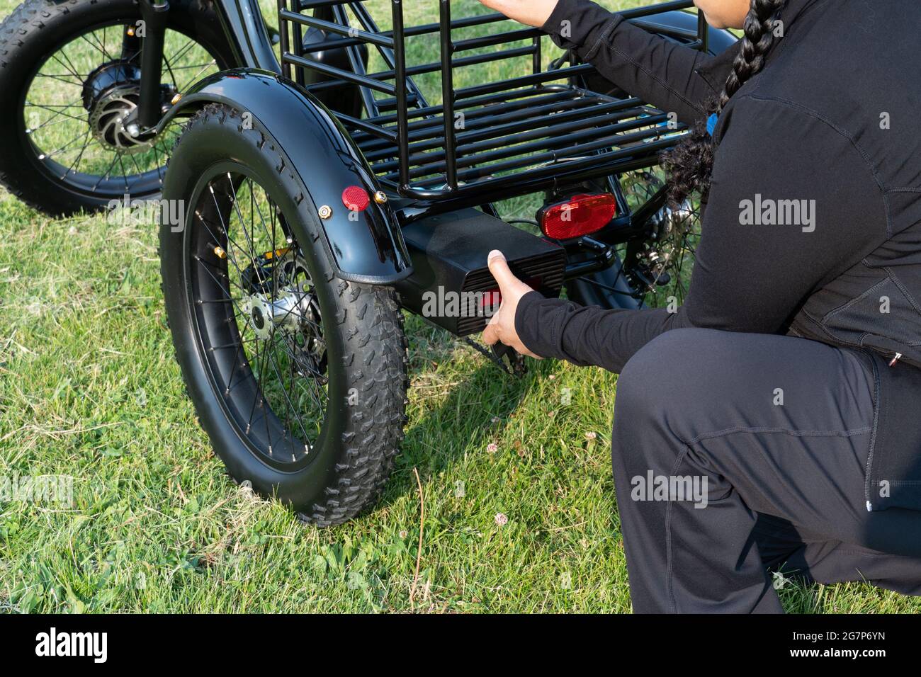 Woman holding battery pack of electric 