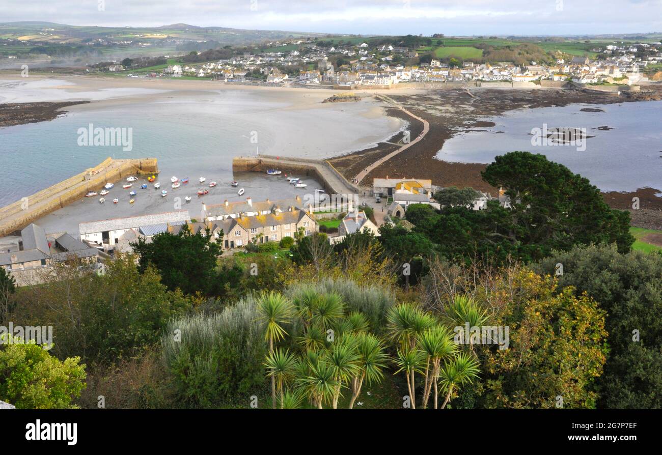 View from the Castle on St Michaels Mount showing the island harbour, causeway to the mainland and the village of Marazion near Penzance in Cornwall. Stock Photo