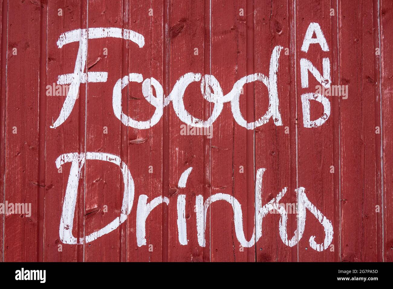 Food and Drinks. White text on red wooden wall in Liuskaluoto Islet, Helsinki, Finland. Stock Photo