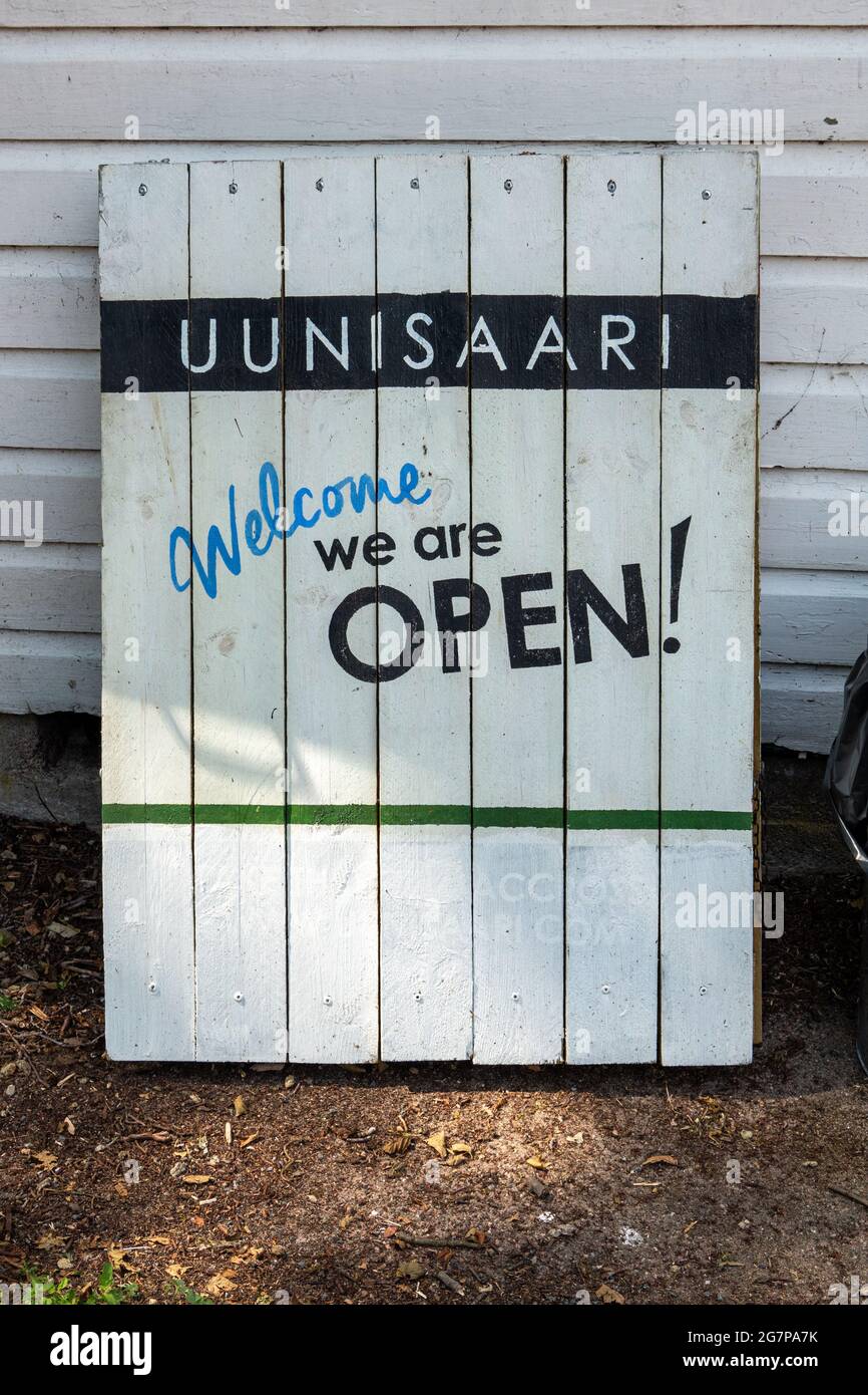 Welcome we are Open! Wooden sign in Uunisaari Island of Helsinki, Finland. Stock Photo