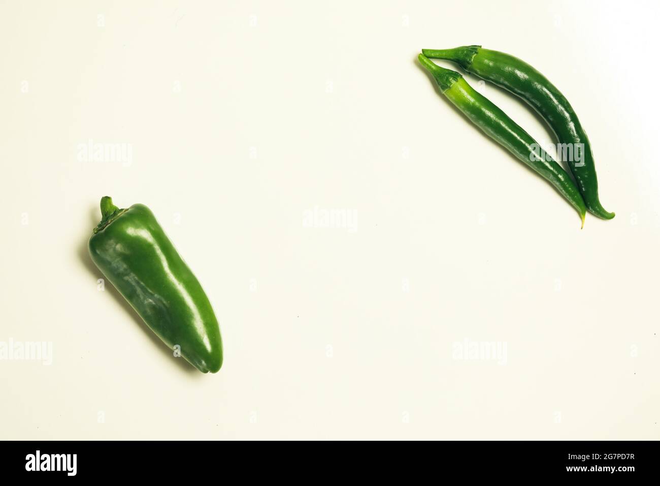 Top view of green chili peppers on a blank background Stock Photo - Alamy