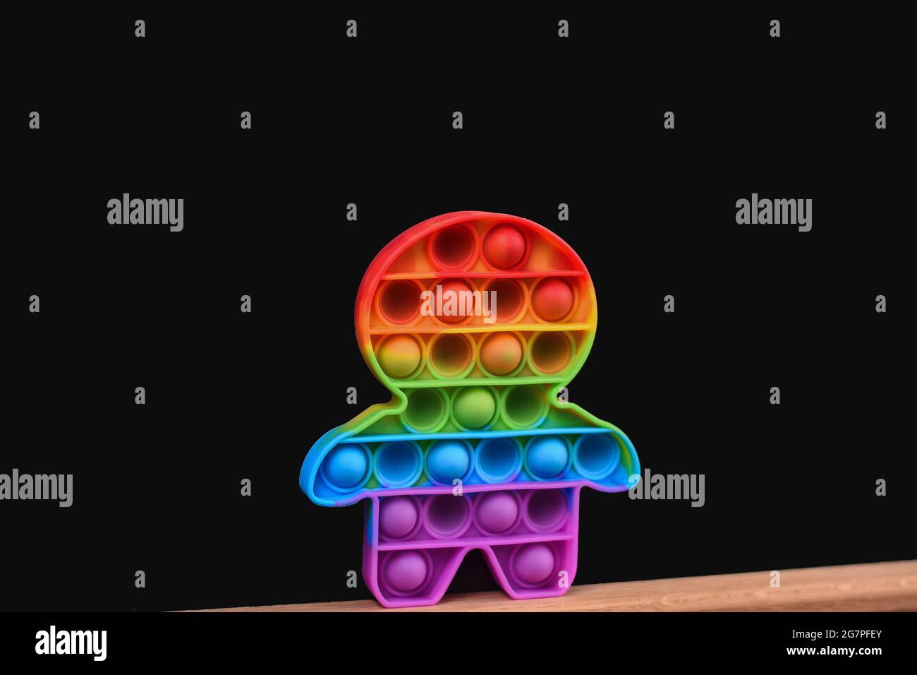 Rainbow Pop it in the form of a man on a black background. Stock Photo