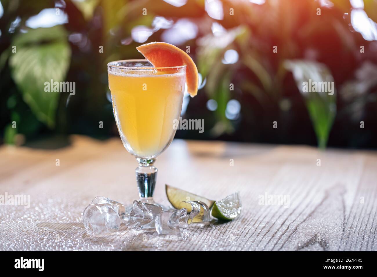 lemonade in glass or refreshing drink with grapefruit, lime and ice on table Stock Photo