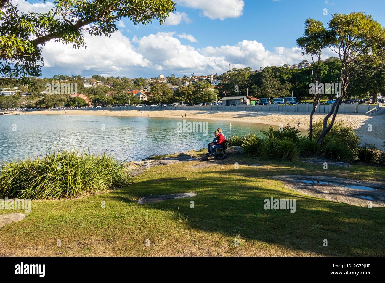People sitting and relaxing on a sunny day at Balmoral Beach, Sydney, Australia, during the pandemic lockdown Stock Photo