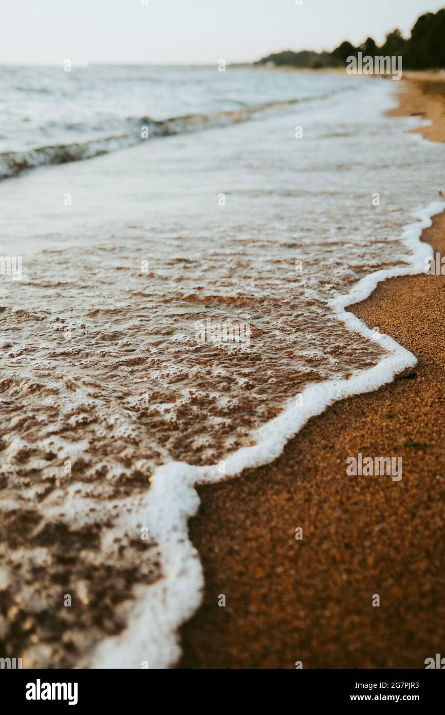 Beautiful scenery of the beach with splashing sea waves Stock Photo - Alamy