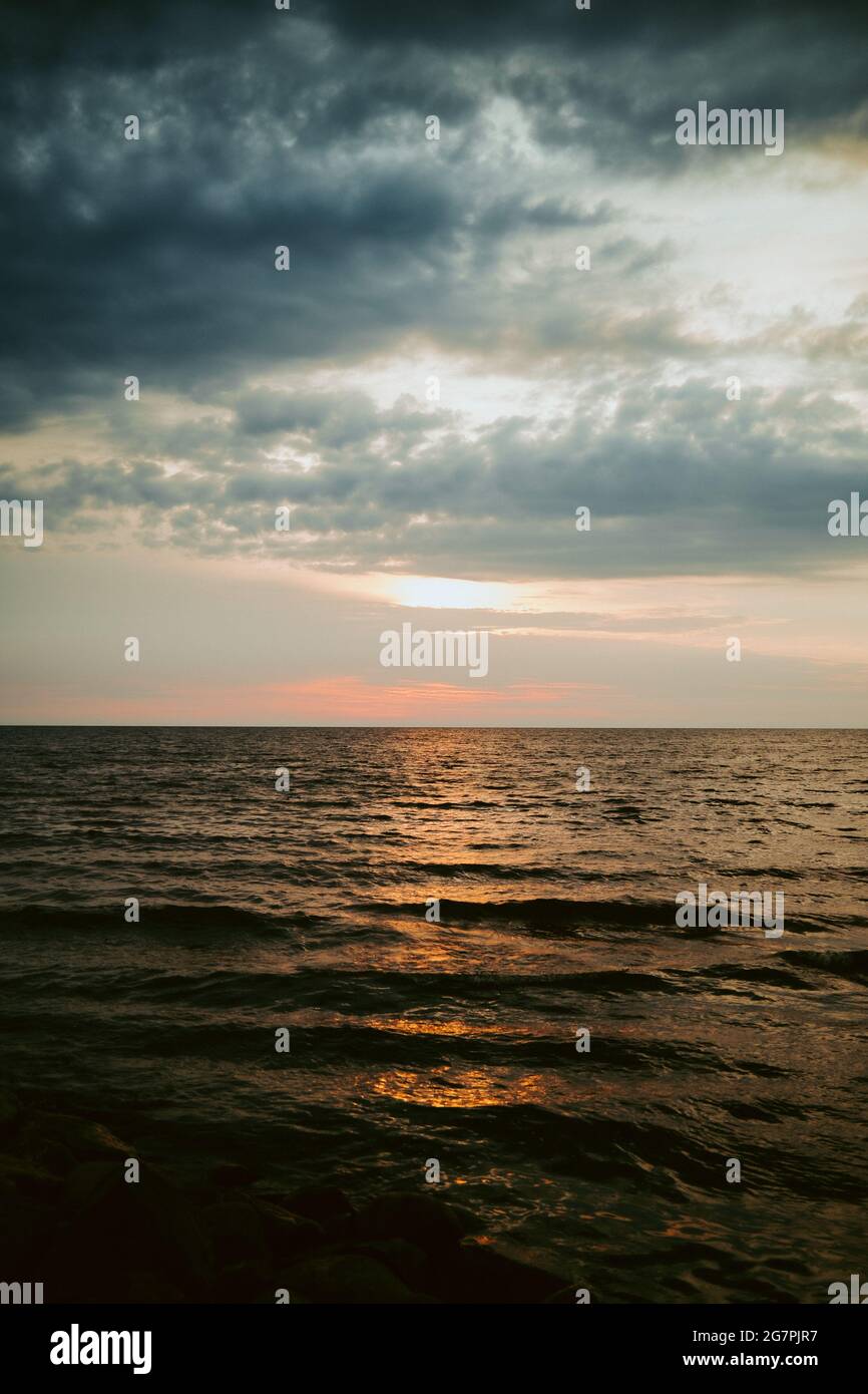 Beautiful scenery of a sea at sunset Stock Photo - Alamy