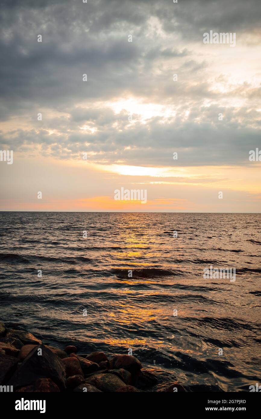 Beautiful scenery of a sea at sunset Stock Photo - Alamy