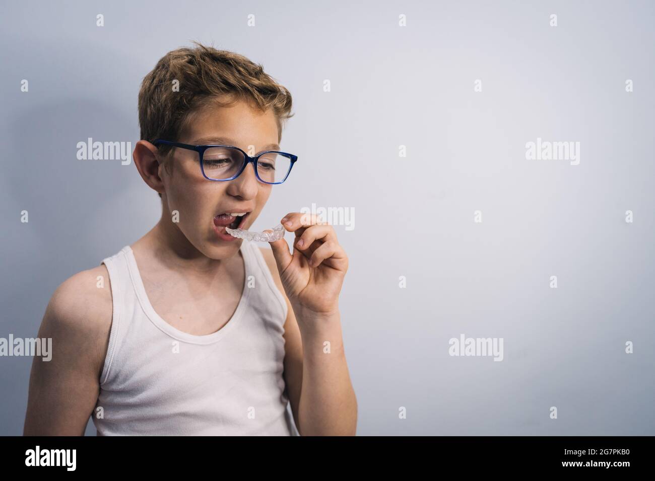 Male caucasian kid with sleeveless shirt wearing the mouthguard Stock Photo