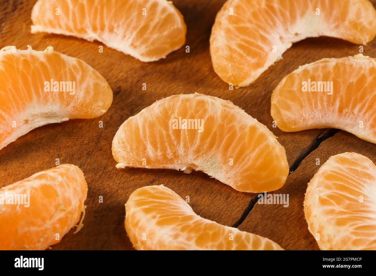 Satsuma Mandarin Tangerine Fruit Wedges On Natural Wood (Citrus unshiu