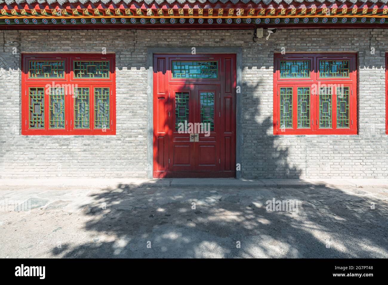 brick wall and red wooden door and window background of an old building ...