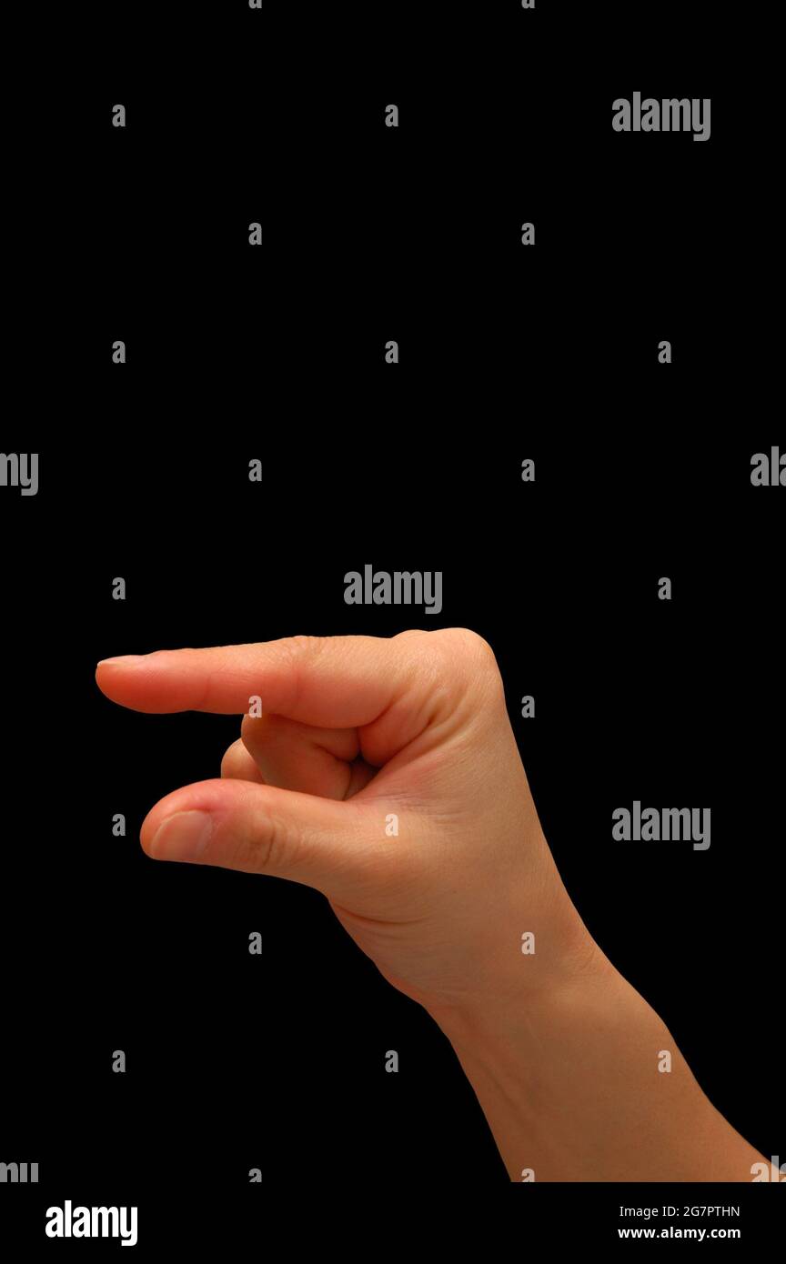 Closeup of a small hand gesture isolated on a black background with ...