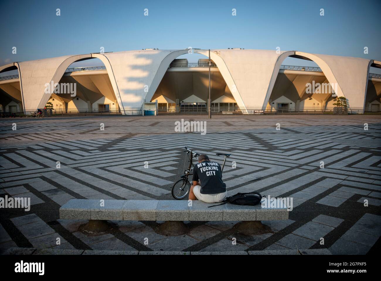 A man reads a book in the plaza inside Komazawa Olympic Park, Tokyo on 10 June 2021. The park was built for the 1964 Tokyo Olympics,  Robert Gilhooly photo Stock Photo