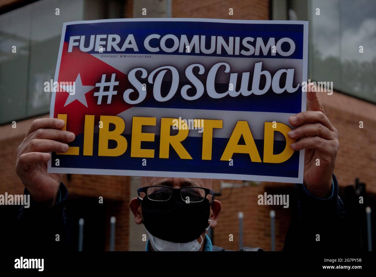 Bogota, Colombia. 15th July, 2021. A demonstrator holds a sign that reads 'No more comunism S.O.S Cuba, Freedom' as Cuban residents that live in Colombia protest against the unrest and violence held in the Island against the government of Cuban president Miguel Diaz-Canel. In Bogota, Colombia on July 15, 2021. Credit: Long Visual Press/Alamy Live News Stock Photo
