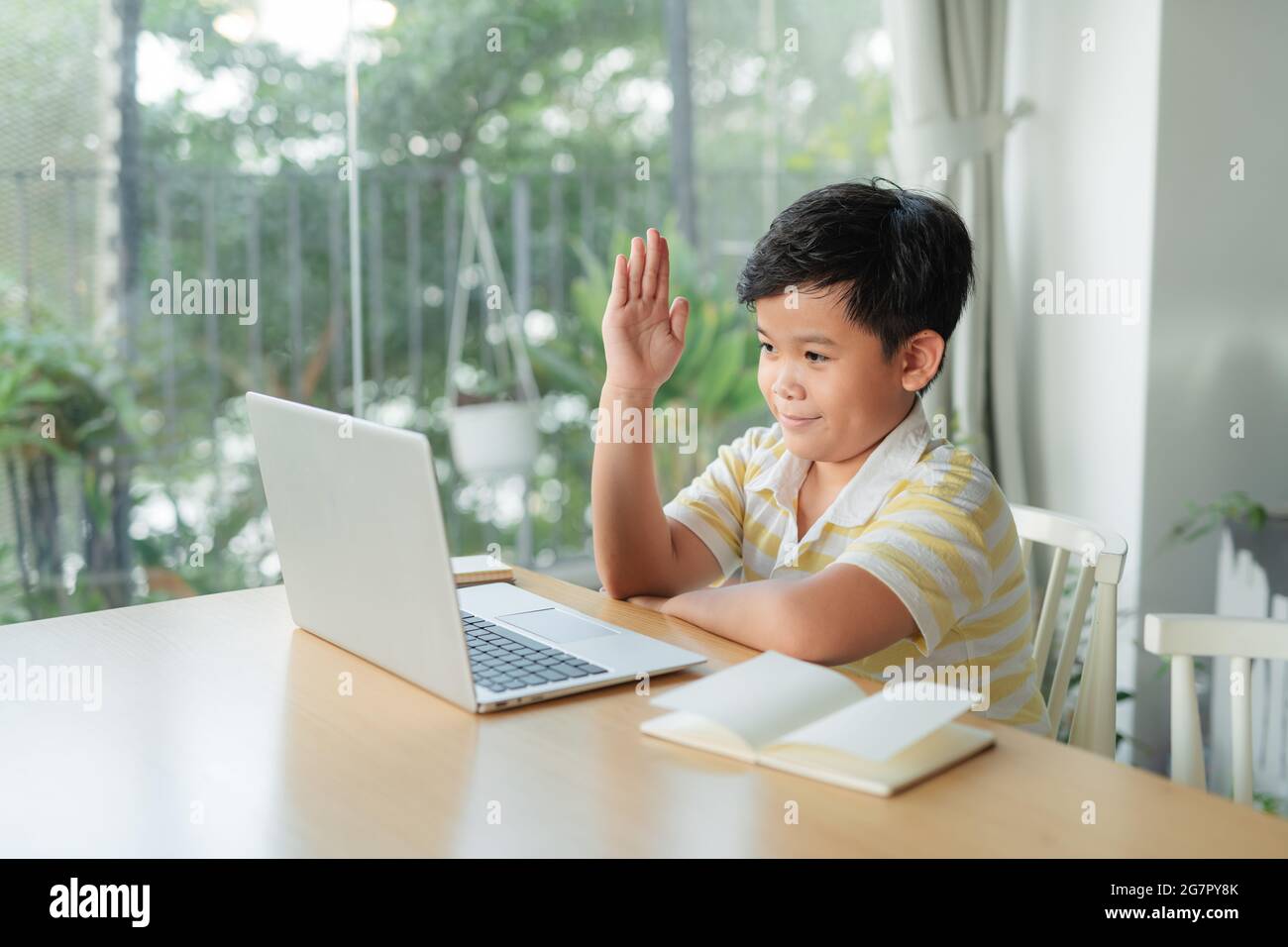 Boy student study online with video call teacher. Stock Photo